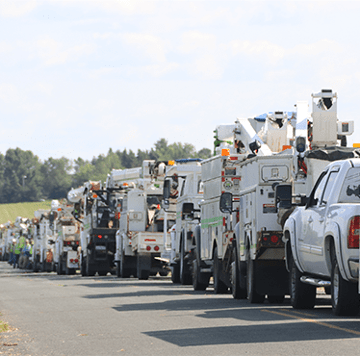 Fleet vehicles parked against blue sky