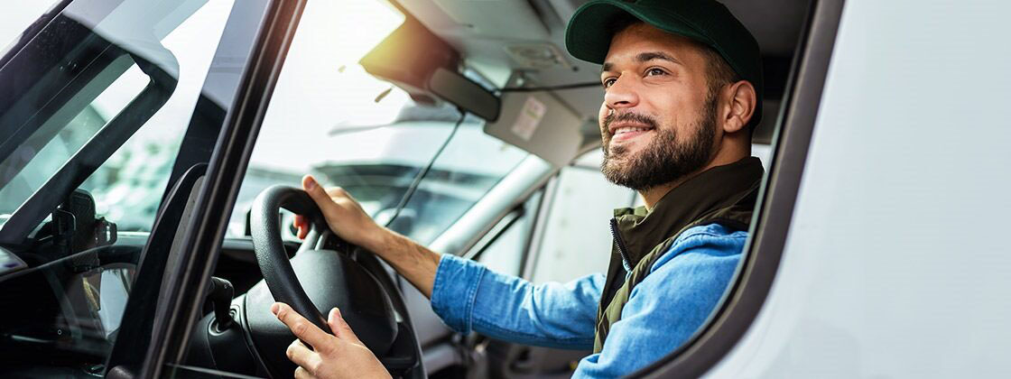 Man driving truck looking out window