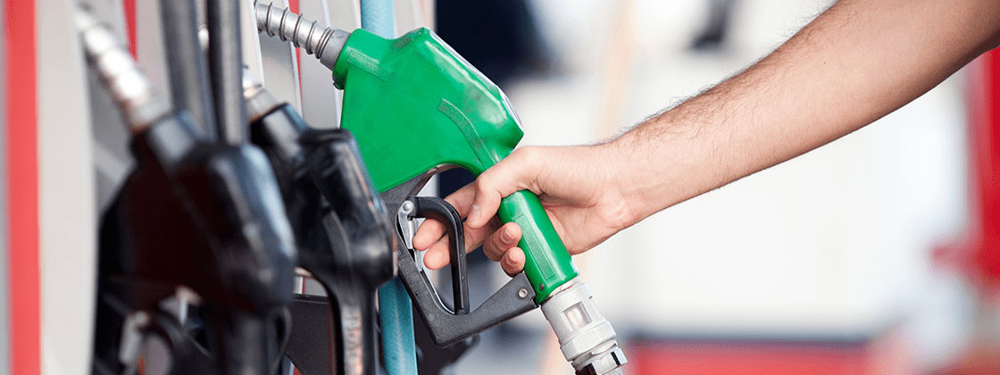 man reaching for fuel pump