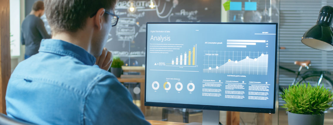 Man reviewing analytics on monitor