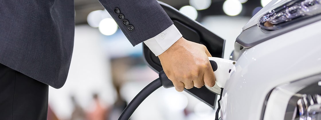 Man plugging in electric vehicle