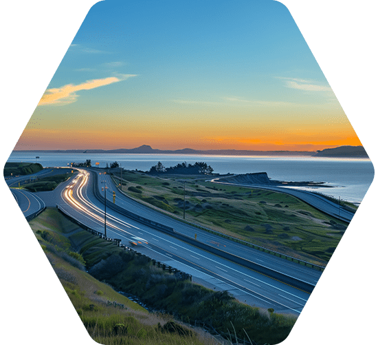 Vehicles driving on a highway at sunset