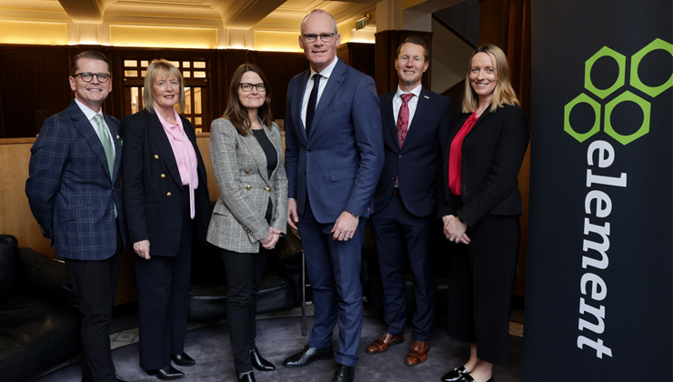 Element Fleet Management Employees standing next to Element banner