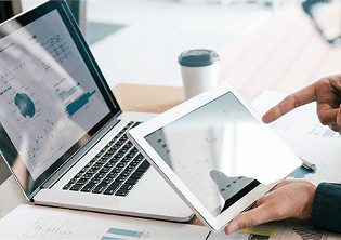 finger pointing at ipad and monitor