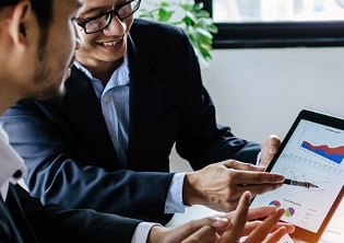 Two men looking at a tablet