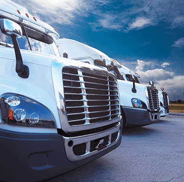 Fleet vehicles parked against blue sky