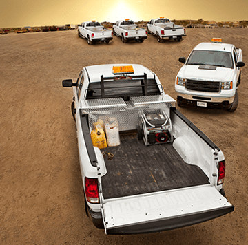 White pickup trucks at oilfield