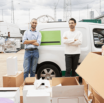 2 men in front of company vehicle