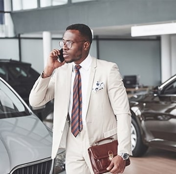 Man talking on his phone while at dealership