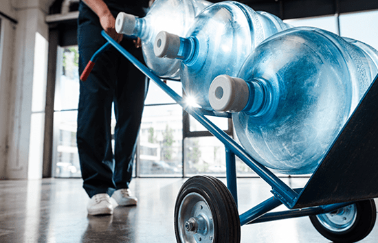 worker delivering water jugs