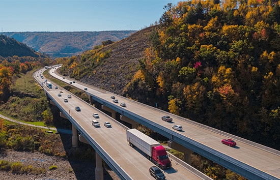 Tractor trailer traveling on a turnpike bridge
