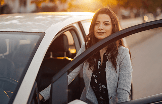 Business woman getting into her vehicle